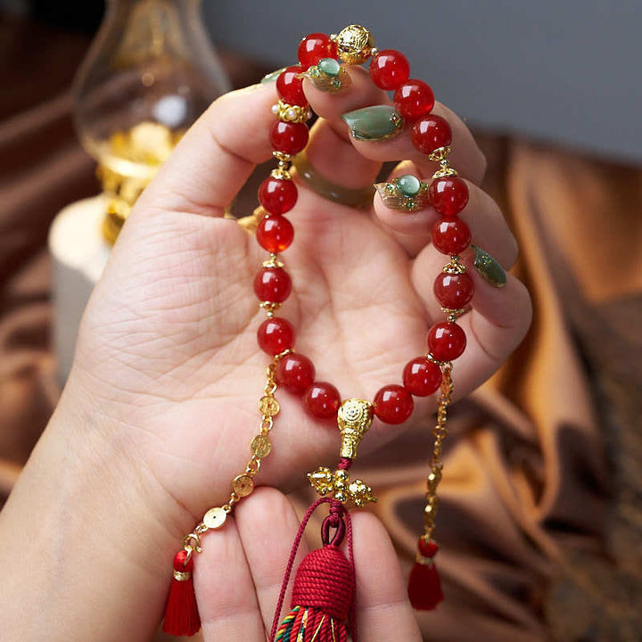 Mala de muñeca con 18 cuentas de Buddha Stones , monedas de cobre, borla tibetana, ágata roja, calmante