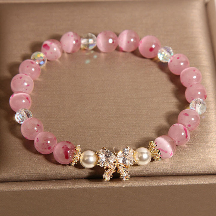 Pulsera de soporte con roseta y lazo de perla de ojo de gato rosa con flor de cerezo y Buddha Stones