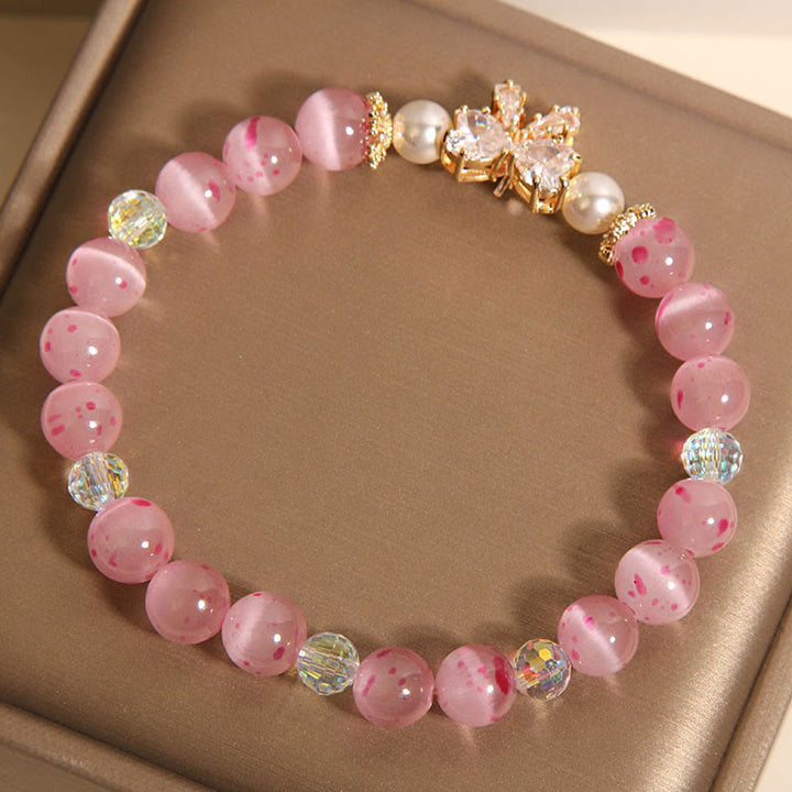 Pulsera de soporte con roseta y lazo de perla de ojo de gato rosa con flor de cerezo y Buddha Stones