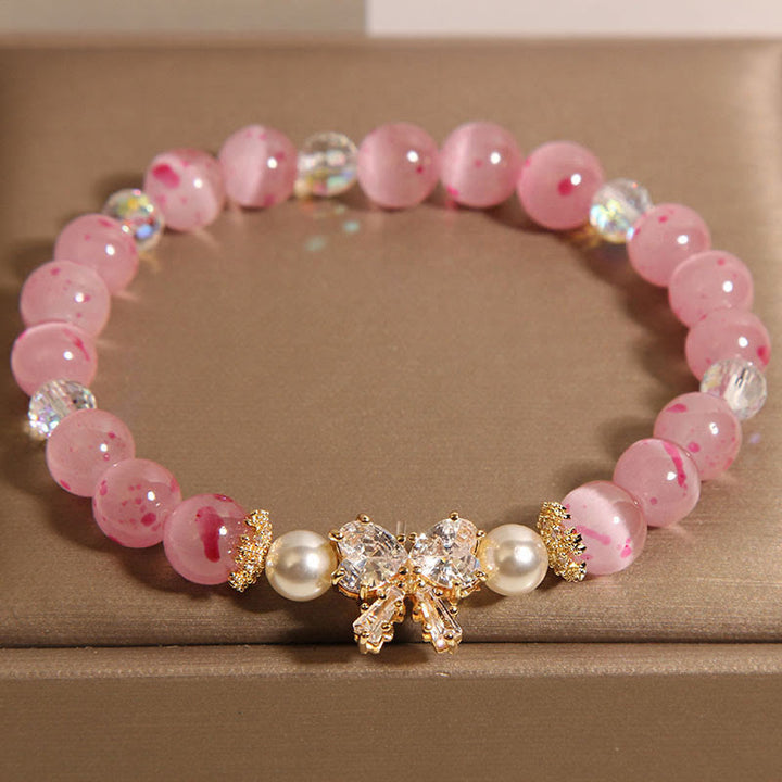 Pulsera de soporte con roseta y lazo de perla de ojo de gato rosa con flor de cerezo y Buddha Stones
