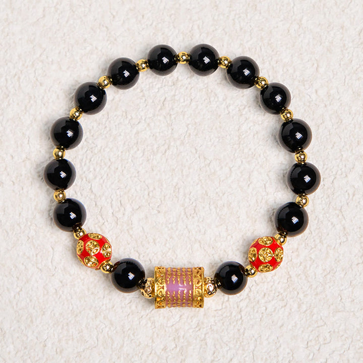 Pulsera de la fortuna con monedas de cobre y cinco escrituras de ónix negro natural de Buddha Stones