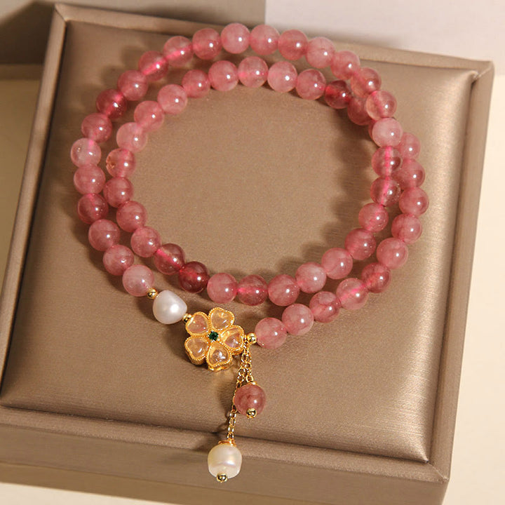 Pulsera positiva con diseño de trébol de cuatro hojas y cuarzo fresa de Buddha Stones