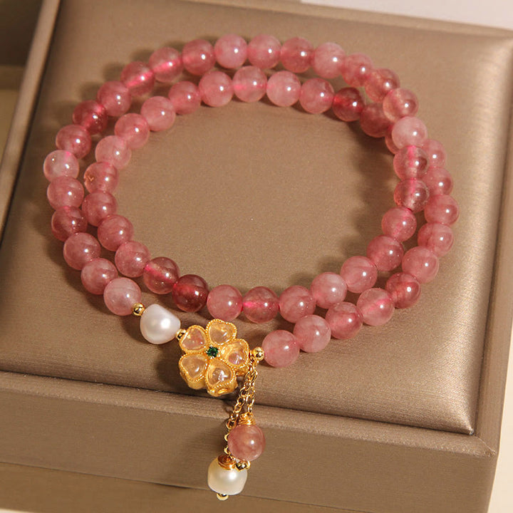 Pulsera positiva con diseño de trébol de cuatro hojas y cuarzo fresa de Buddha Stones