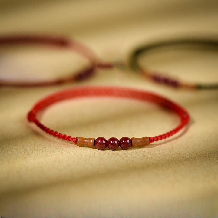 Pulsera de hilo bendecido de madera de melocotón con cuentas de cinabrio y Buddha Stones