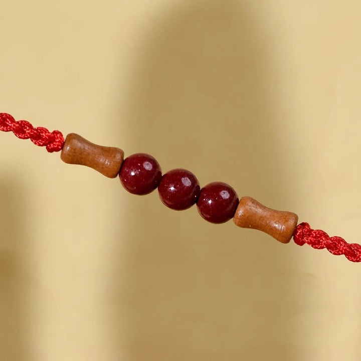 Pulsera de hilo bendecido de madera de melocotón con cuentas de cinabrio y Buddha Stones