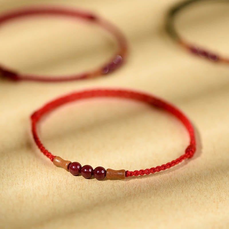 Pulsera de hilo bendecido de madera de melocotón con cuentas de cinabrio y Buddha Stones
