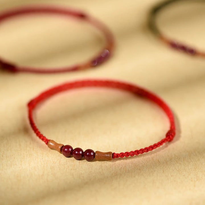Pulsera de hilo bendecido de madera de melocotón con cuentas de cinabrio y Buddha Stones