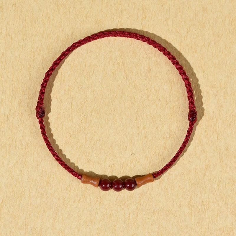 Pulsera de hilo bendecido de madera de melocotón con cuentas de cinabrio y Buddha Stones