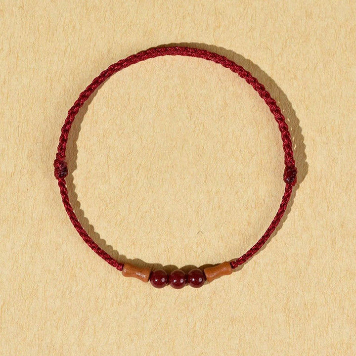 Pulsera de hilo bendecido de madera de melocotón con cuentas de cinabrio y Buddha Stones