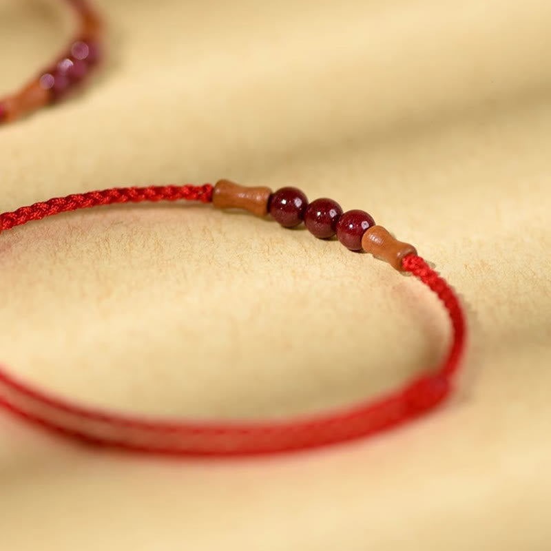 Pulsera de hilo bendecido de madera de melocotón con cuentas de cinabrio y Buddha Stones