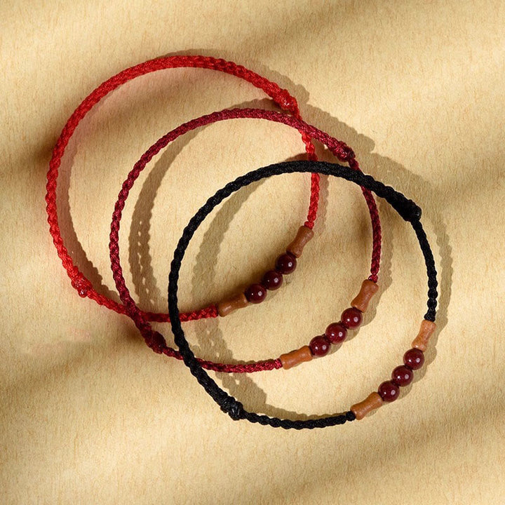 Pulsera de hilo bendecido de madera de melocotón con cuentas de cinabrio y Buddha Stones