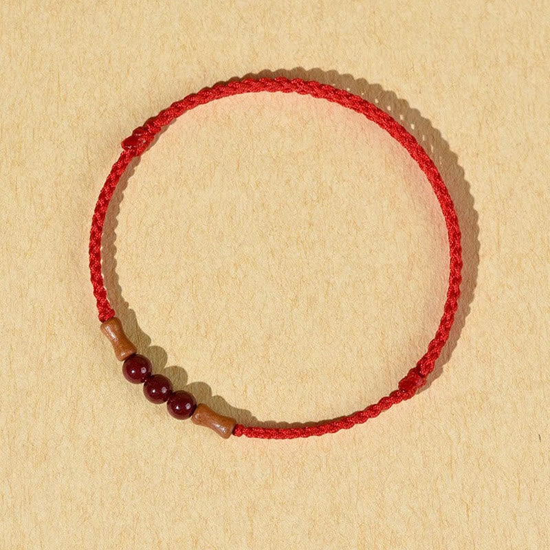 Pulsera de hilo bendecido de madera de melocotón con cuentas de cinabrio y Buddha Stones