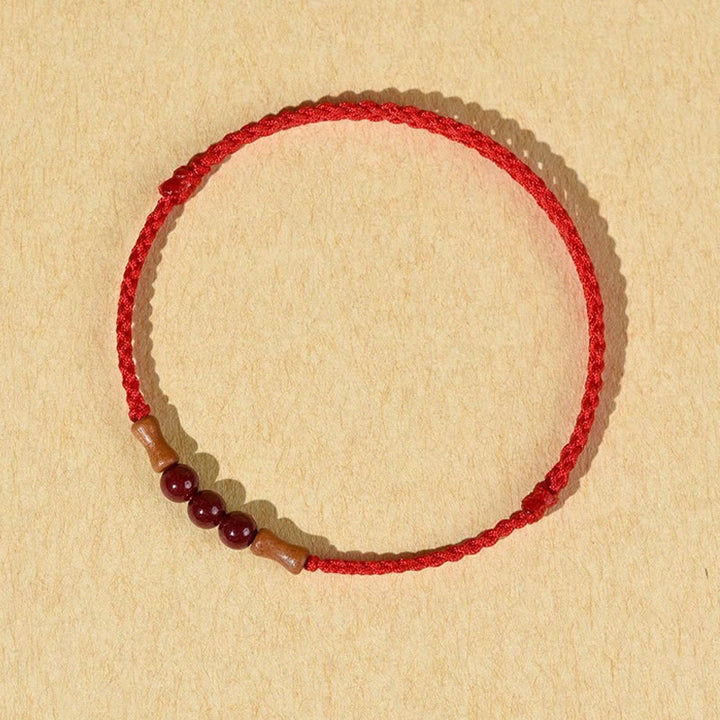 Pulsera de hilo bendecido de madera de melocotón con cuentas de cinabrio y Buddha Stones