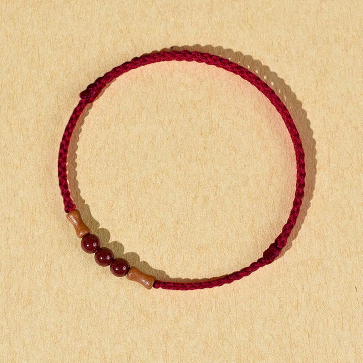 Pulsera de hilo bendecido de madera de melocotón con cuentas de cinabrio y Buddha Stones