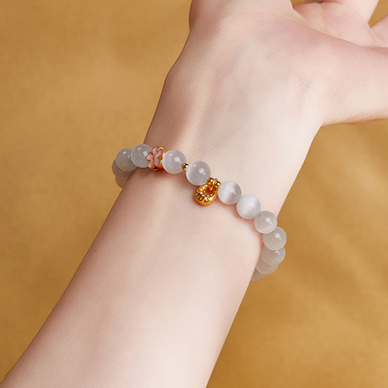 Pulsera con Buddha Stones en plata de ley 925 con ojo de gato blanco y flor de melocotón natural