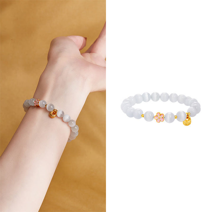 Pulsera con Buddha Stones en plata de ley 925 con ojo de gato blanco y flor de melocotón natural