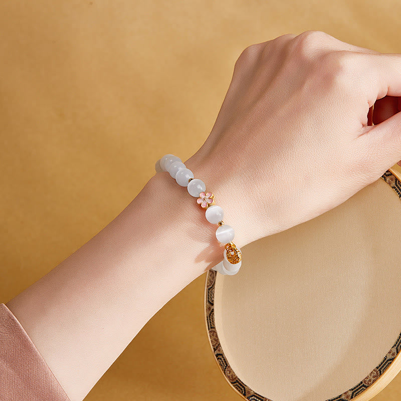 Pulsera con Buddha Stones en plata de ley 925 con ojo de gato blanco y flor de melocotón natural