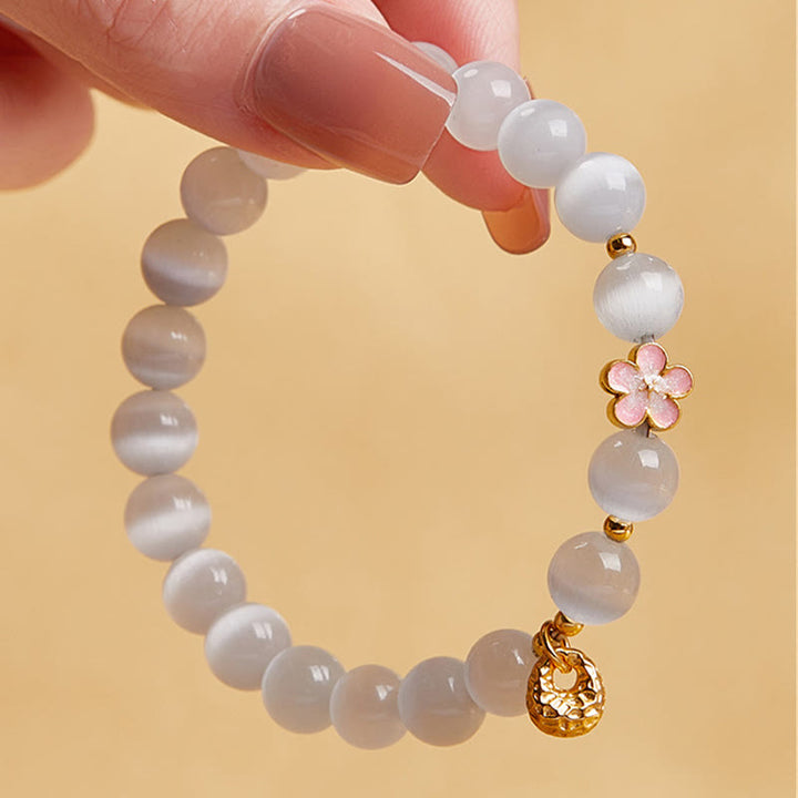 Pulsera con Buddha Stones en plata de ley 925 con ojo de gato blanco y flor de melocotón natural