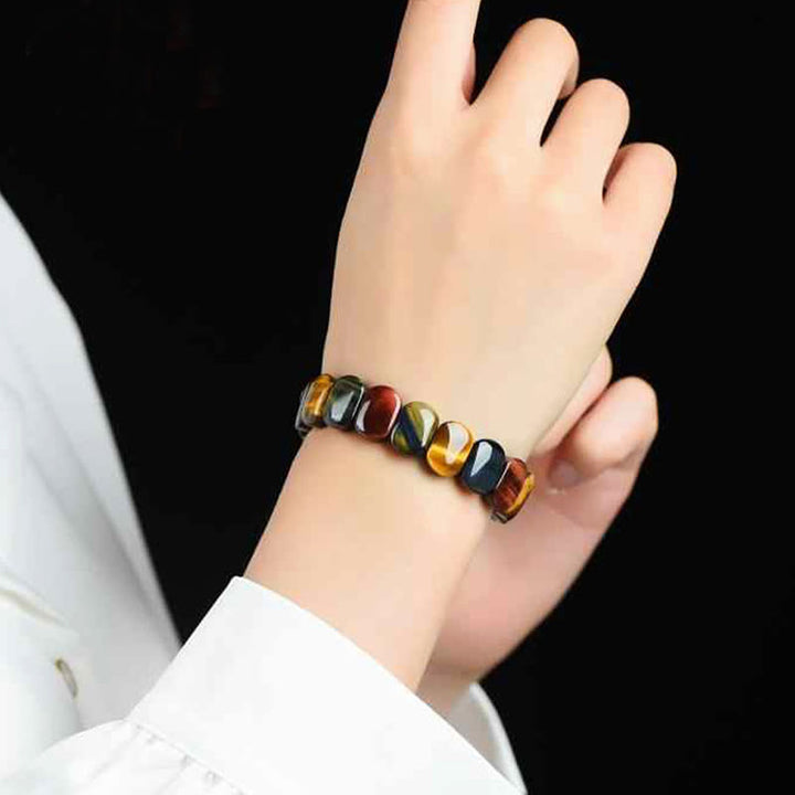 Pulsera de fuerza con cuentas ovaladas de ojo de tigre de colores naturales de Buddha Stones