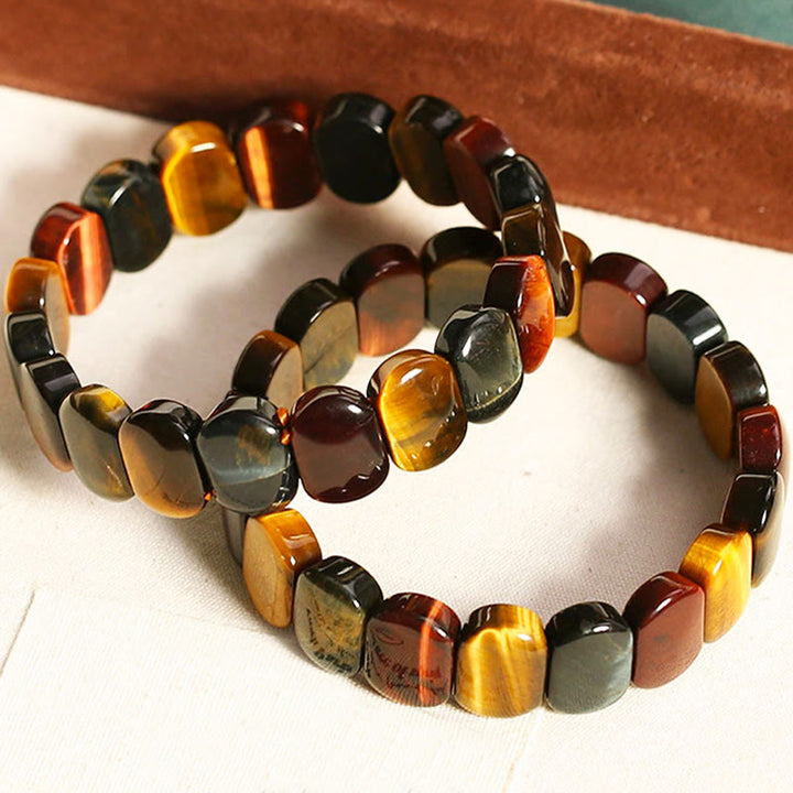 Pulsera de fuerza con cuentas ovaladas de ojo de tigre de colores naturales de Buddha Stones