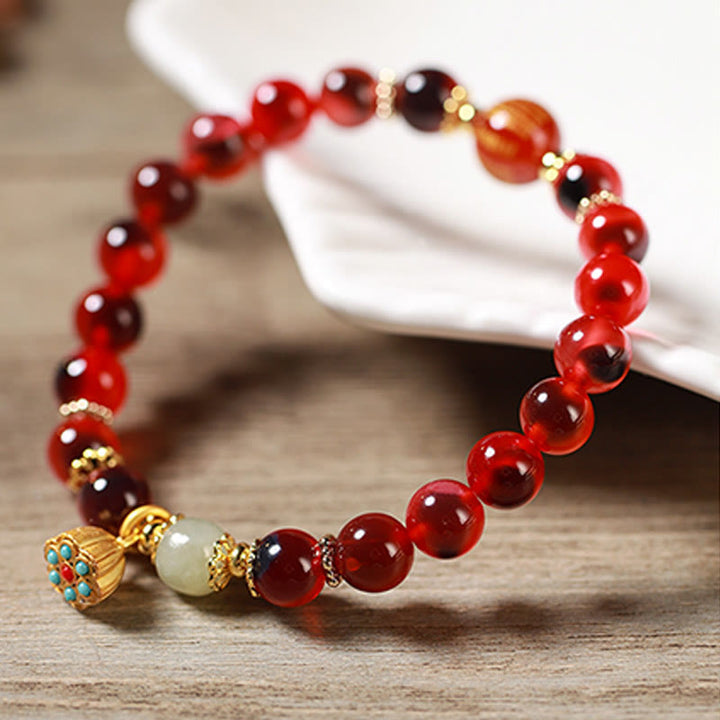 Pulsera curativa con vaina de loto dorado y ágata de caramelo natural de Buddha Stones - image 18