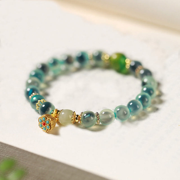 Pulsera curativa con vaina de loto dorado y ágata de caramelo natural de Buddha Stones - Ágata de caramelo azul (circunferencia de la muñeca: 14-15 cm) - image 1