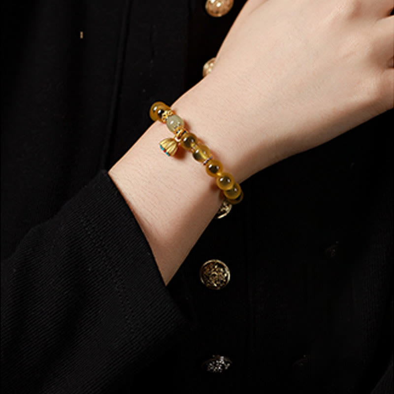 Pulsera curativa con vaina de loto dorado y ágata de caramelo natural de Buddha Stones - image 11