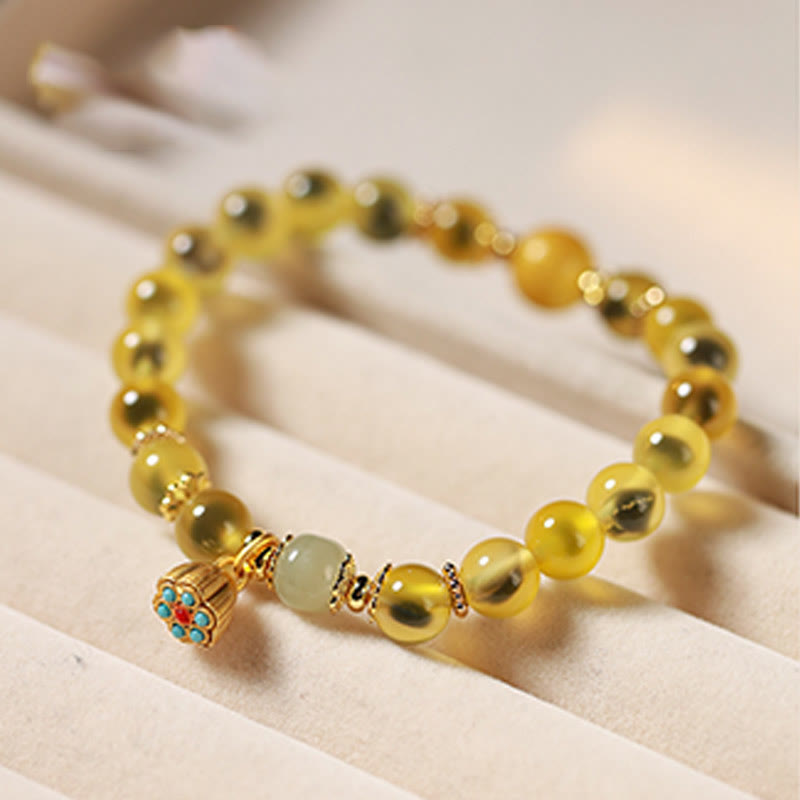 Pulsera curativa con vaina de loto dorado y ágata de caramelo natural de Buddha Stones - image 10