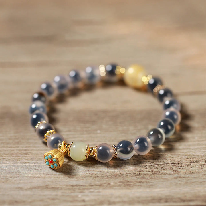 Pulsera curativa con vaina de loto dorado y ágata de caramelo natural de Buddha Stones - image 13