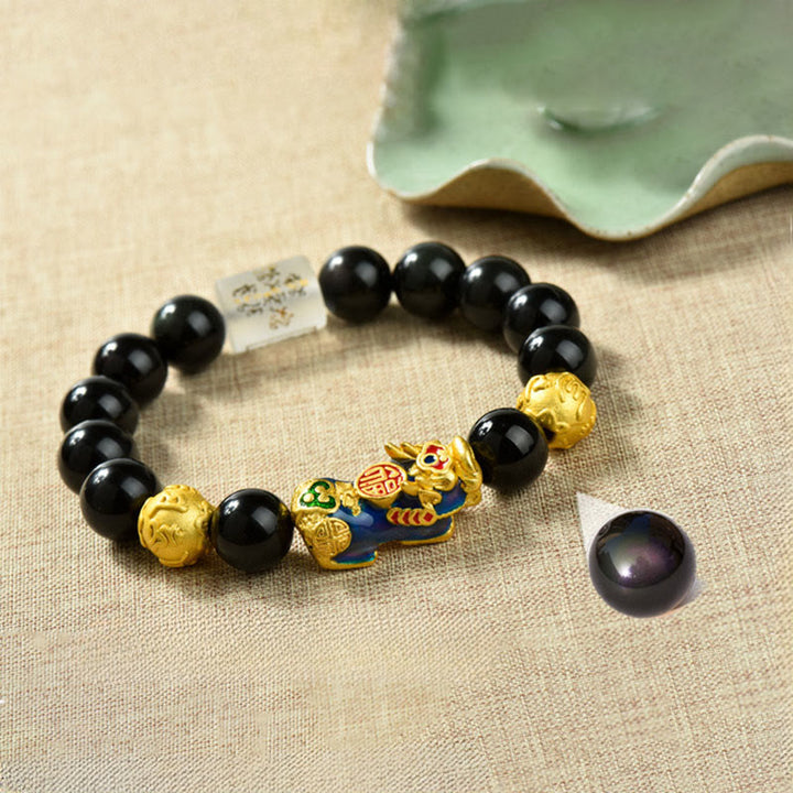 Pulsera de la riqueza con cuentas de obsidiana arcoíris de cobre Pixiu y Buddha Stones Feng Shui - Personaje Om Mani Padme Hum y Fu y Pixiu que cambia de color (circunferencia de la muñeca: 18-19 cm) - image 1