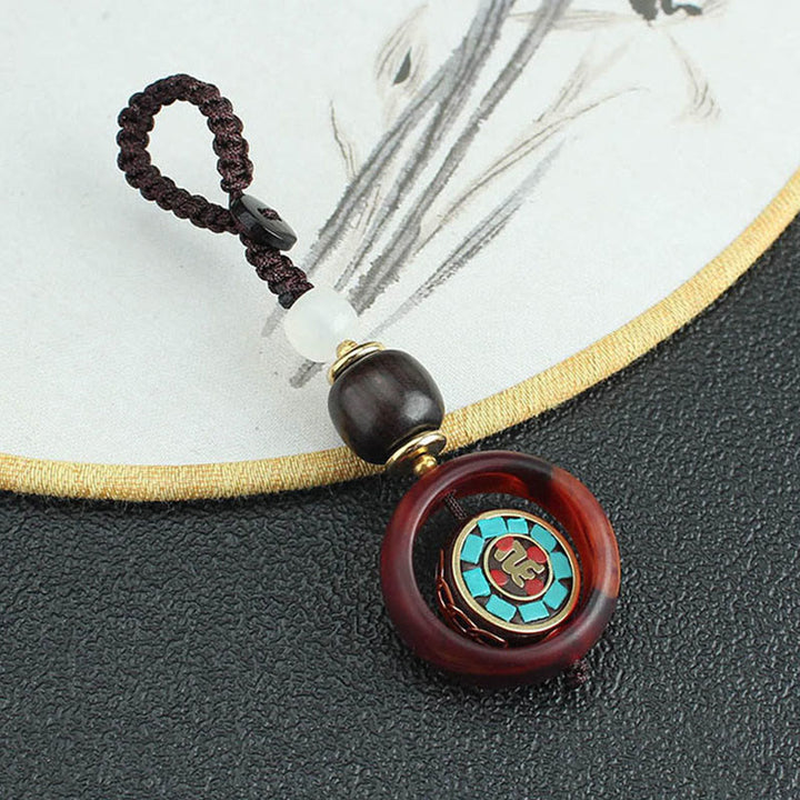 Llavero giratorio con Buddha Stones, madera de ébano, trébol de cuatro hojas en sánscrito, ojo de Buda y paz. - image 1