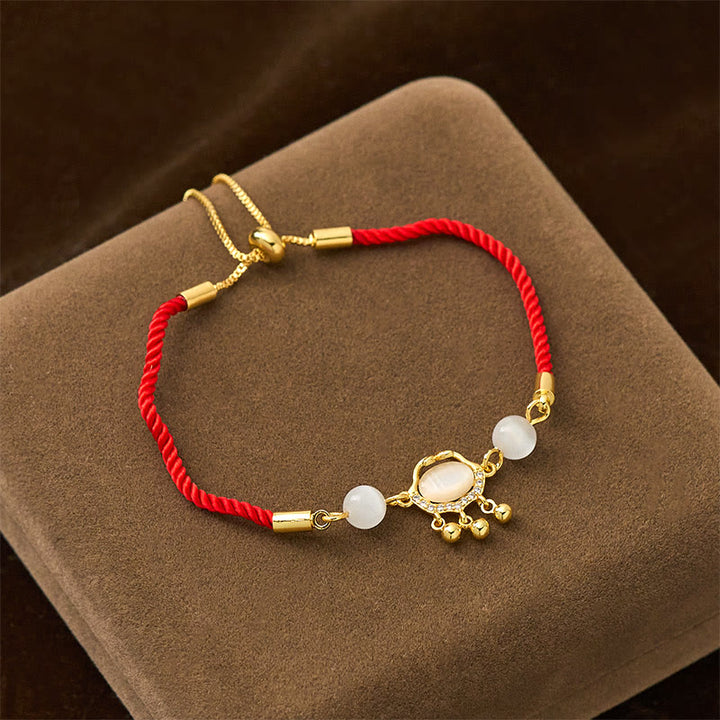 Pulsera protectora chapada en oro y cobre con abalorio de ojo de gato y Buddha Stones - image 1