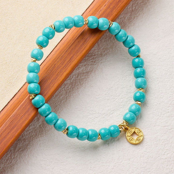 Pulsera de turquesa de imitación con dije de monedas de cobre y Buddha Stones - image 1