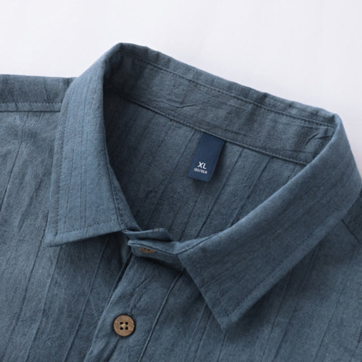 Camisa de algodón y ramio de manga corta con diseño plisado liso de verano para hombre con medio botón y diseño de Buddha Stones - image 1