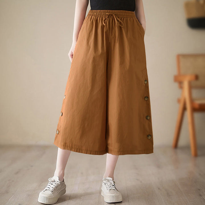 Buddha Stones Pantalones capri de pierna ancha para mujer con diseño abotonado lateral liso y bolsillos - image 0