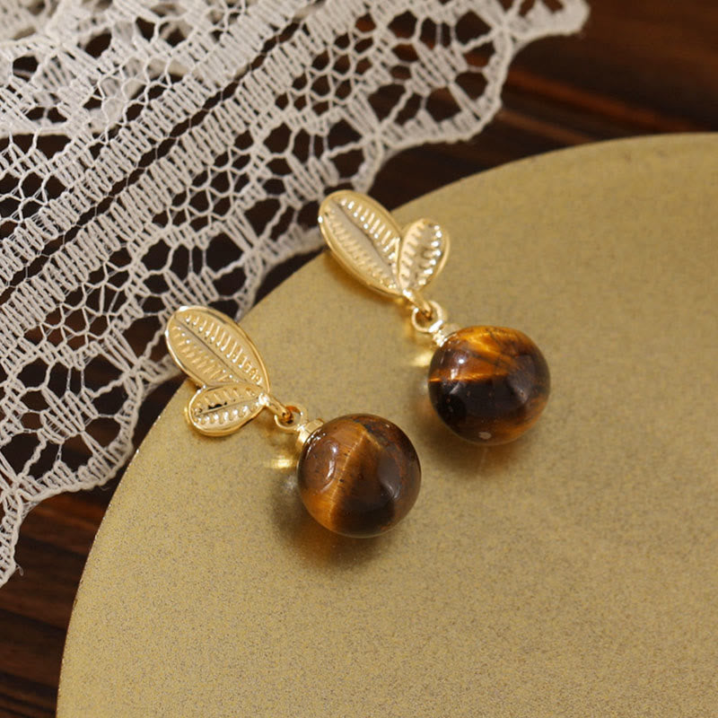 Buddha Stones Pendientes de protección de cobre con diseño de hojas de ojo de tigre - image 1