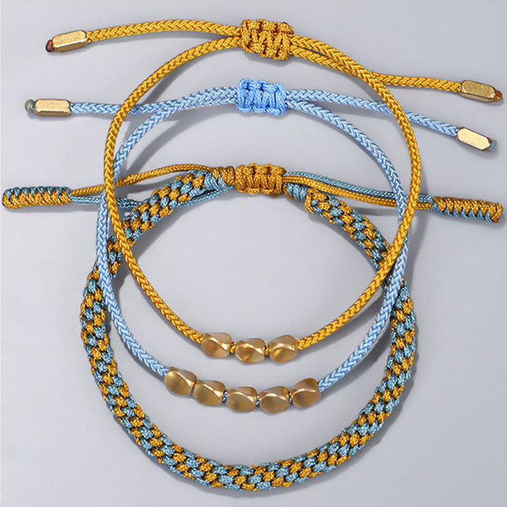Buddha Stones Pulsera curativa de 3 piezas con cuentas de cobre dorado y hilo azul y amarillo. - image 1