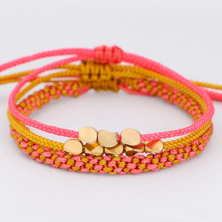 Buddha Stones Pulsera de la riqueza de 3 piezas con cuentas de cobre dorado y rosa y hilo amarillo. - image 1