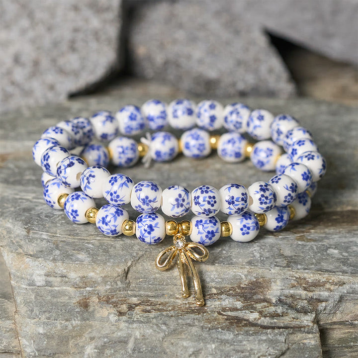Buddha Stones Pulsera de cuentas de porcelana azul, blanca y rosa con lazo y palabra de honor - image 1