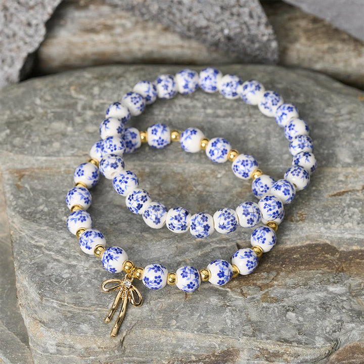 Buddha Stones Pulsera de cuentas de porcelana azul, blanca y rosa con lazo y palabra de honor - image 2