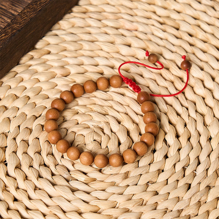 Buddha Stones Mala de muñeca de cuentas de sándalo tibetano para enraizar - image 1