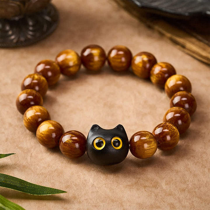 Buddha Stones Pulsera con cuentas de resina amarilla, ojos amarillos y diseño de gato tranquilo en madera de ébano. - image 1