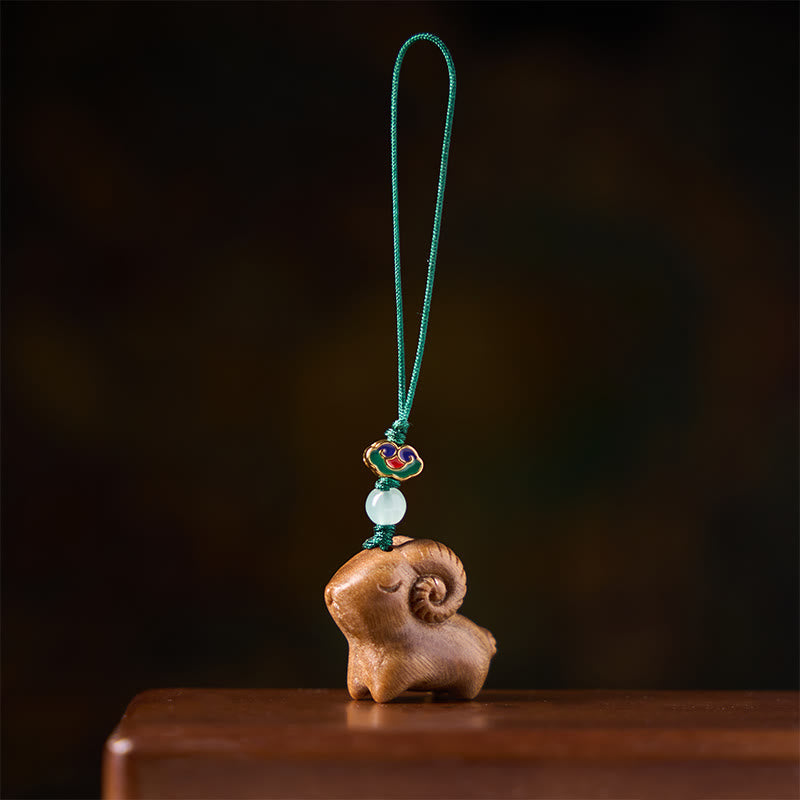 Buddha Stones Llaveros con forma de cabra tallados a mano en madera de sándalo - image 1