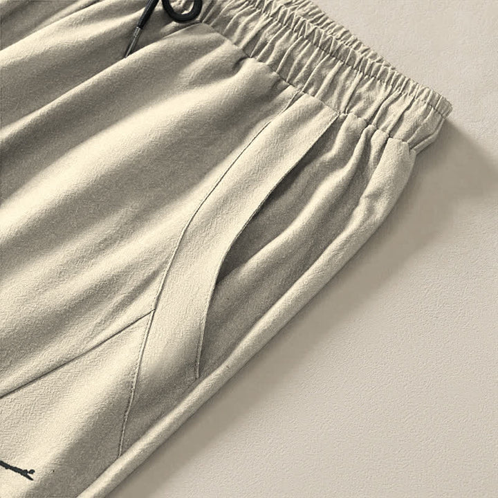 Buddha Stones Pantalones de hombre de algodón puro con estampado de flores de ciruelo y cordón ajustable, corte cónico y bolsillos. - image 4
