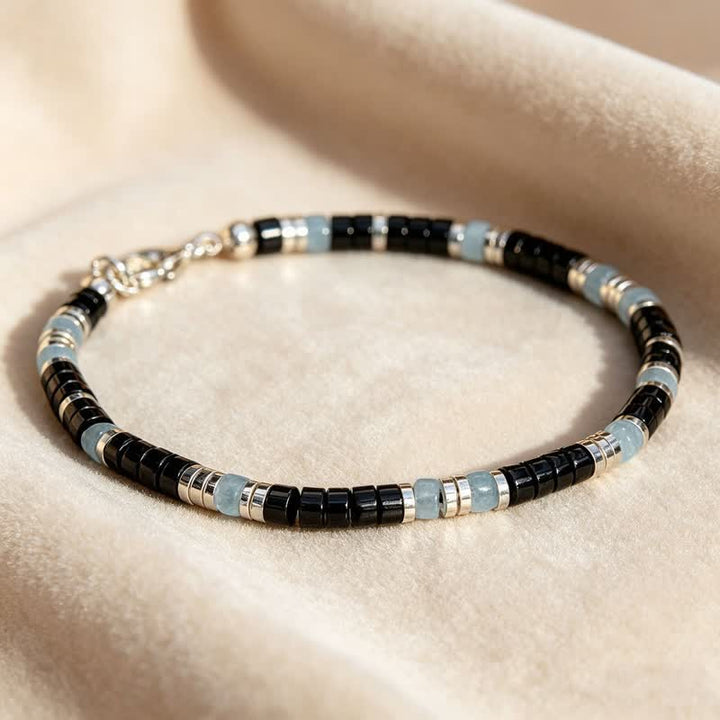 Buddha Stones Pulsera elástica de cuentas de protección con calcedonia azul y ónix negro - image 1