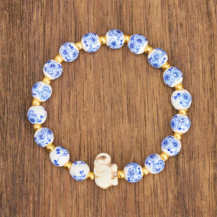 Buddha Stones Pulsera redonda de cuentas florales con forma de elefante de porcelana blanca - image 1