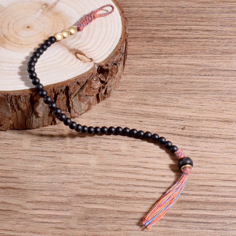 Pulsera con borlas de ónix negro tibetano hecha a mano con Buddha Stones
