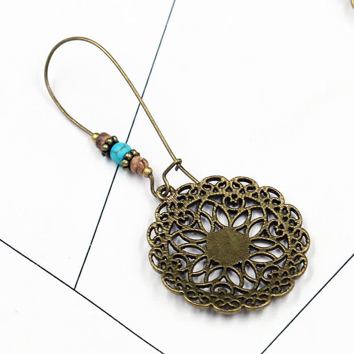 Pendientes colgantes redondos de la suerte con diseño de flores
