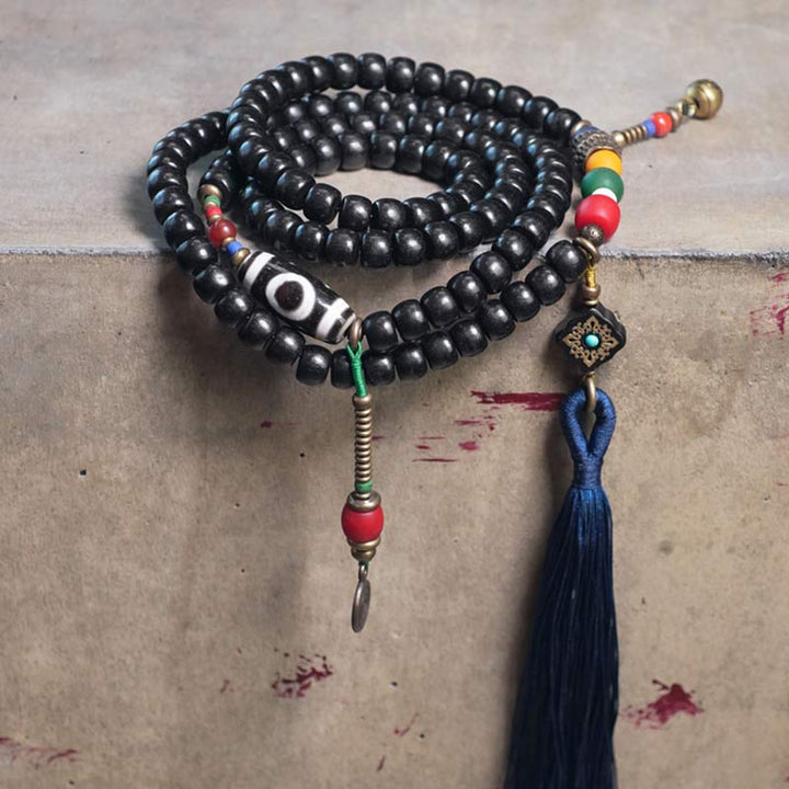 Buddha Stones 108 cuentas Mala madera de ébano cuentas Dzi cobre equilibrio borla pulsera