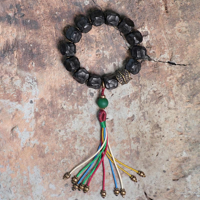 Pulsera Mala de muñeca con borla de paz de cobre y madera de ébano del Tíbet